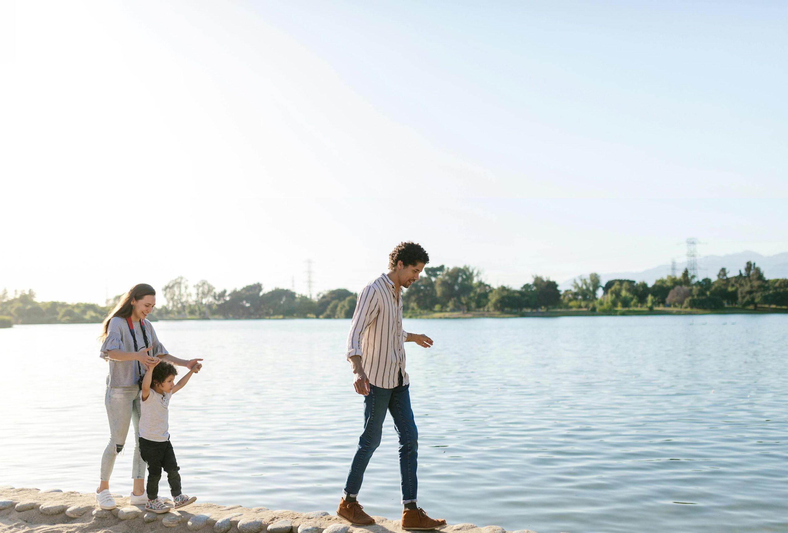 family walking on a shoreline